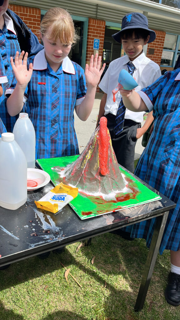 Year 6 Science students making their own volcanoes 