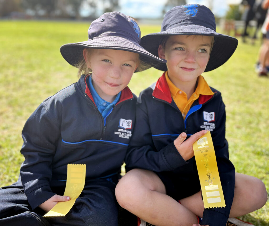 Junior School students running cross country and celebrating with their medals 
